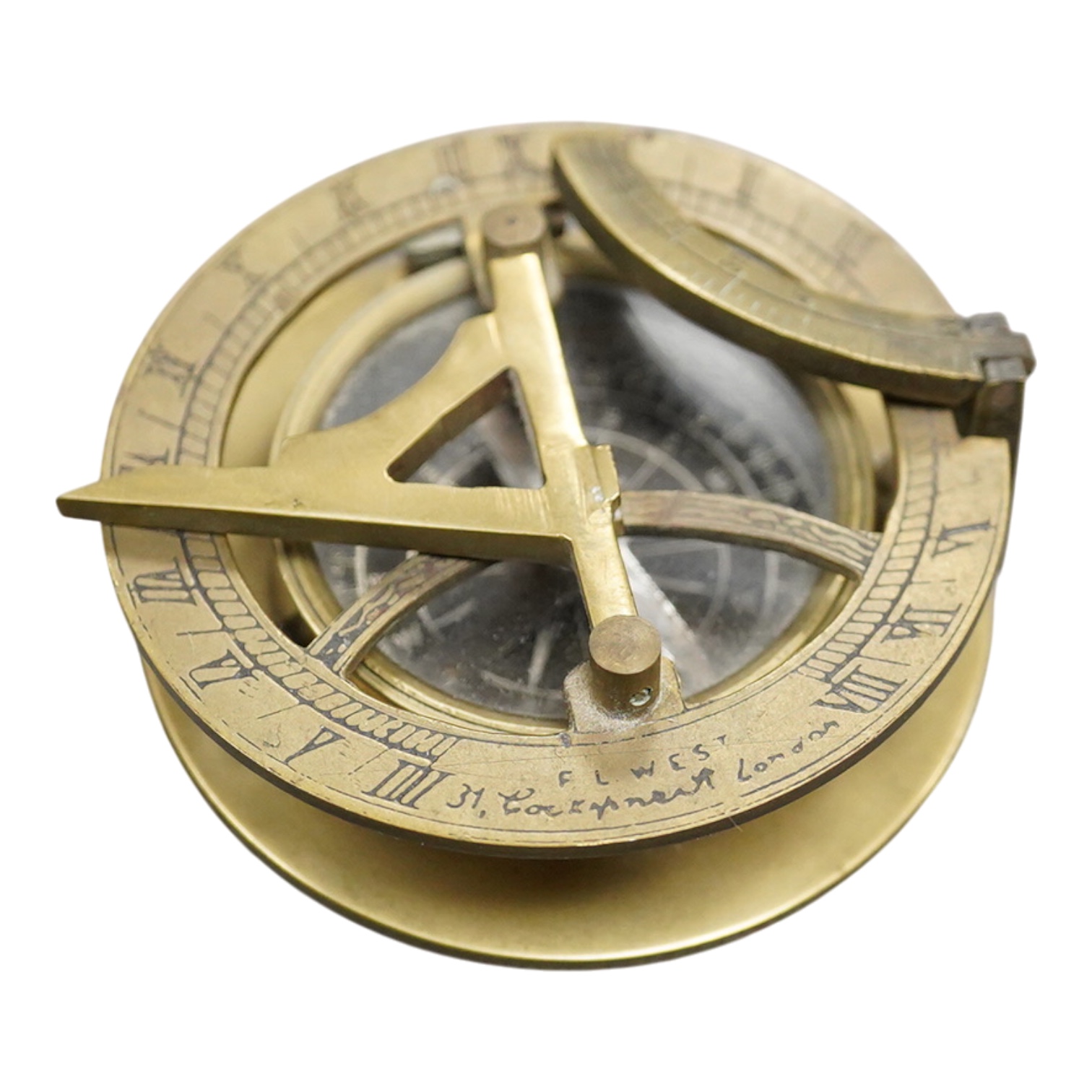A mid 19th century brass pocket sundial, by F.L. West, 31, Cockspur St., London, with a folding gnomon and latitude scale, 6.5cm diameter